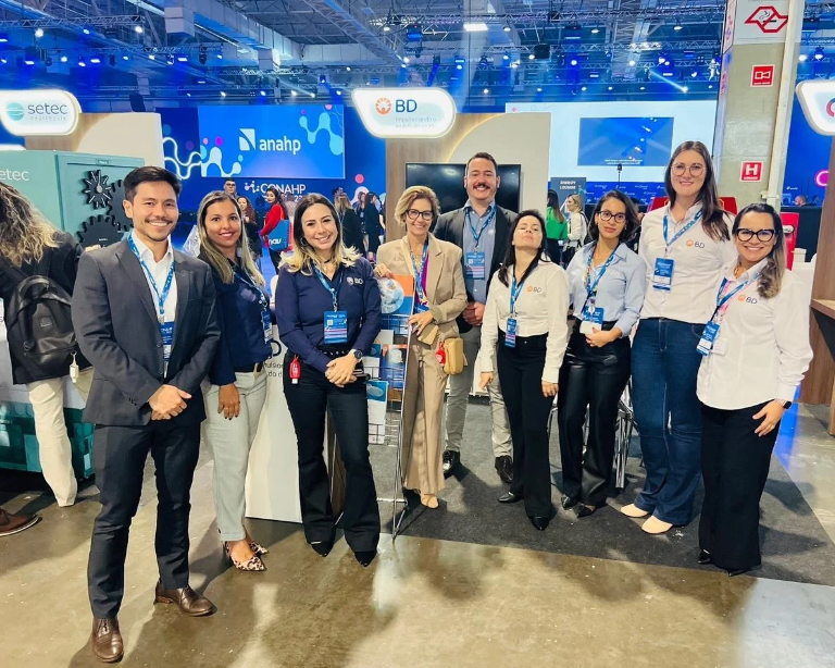 BD team members posing together at an industry conference booth.