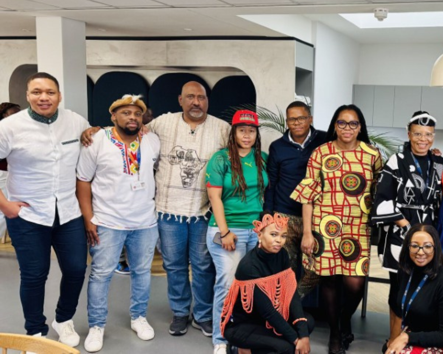 Group of BD associates standing together inside an office space