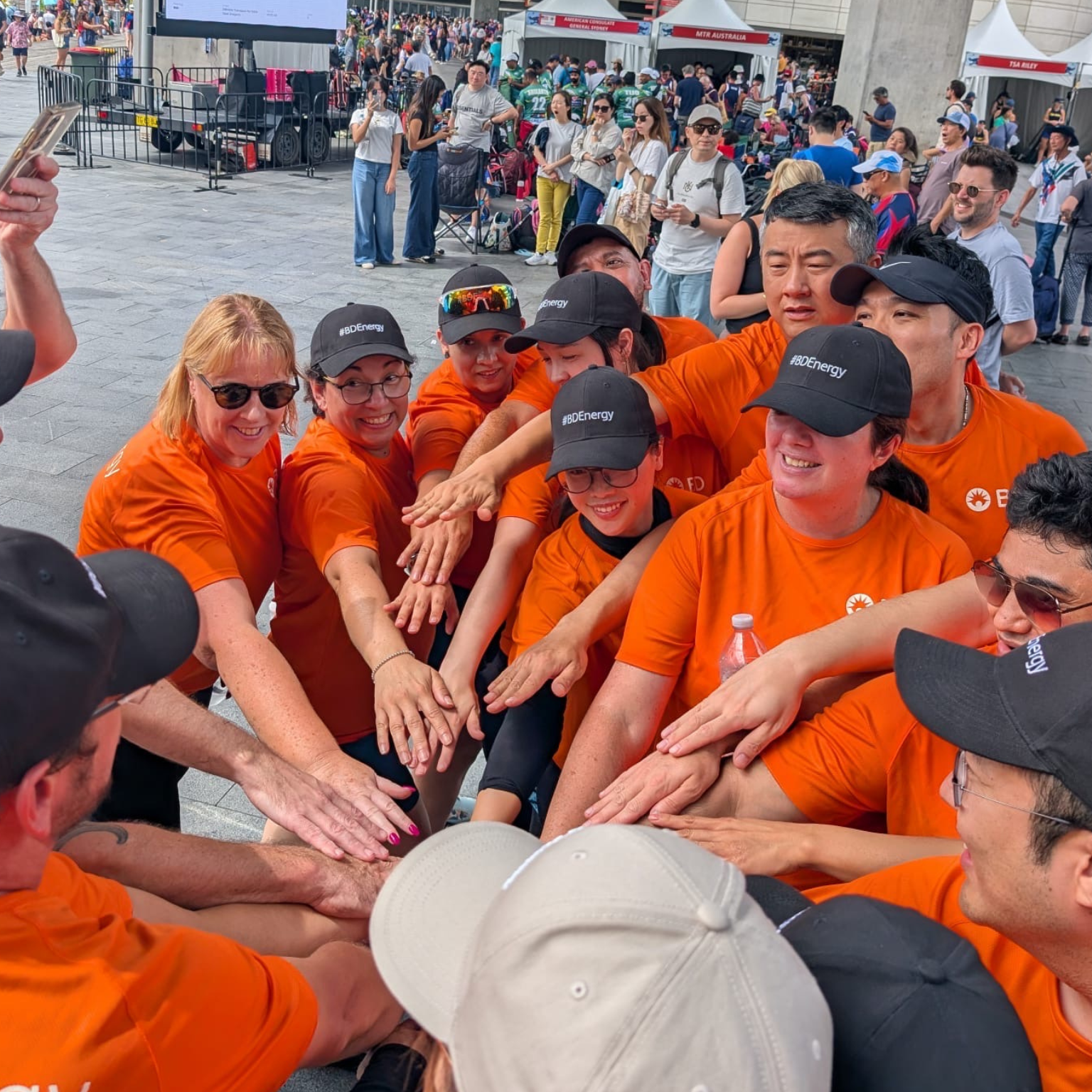Large group of BD associates putting their hands together at Dragon Boat Lunar New Year Event