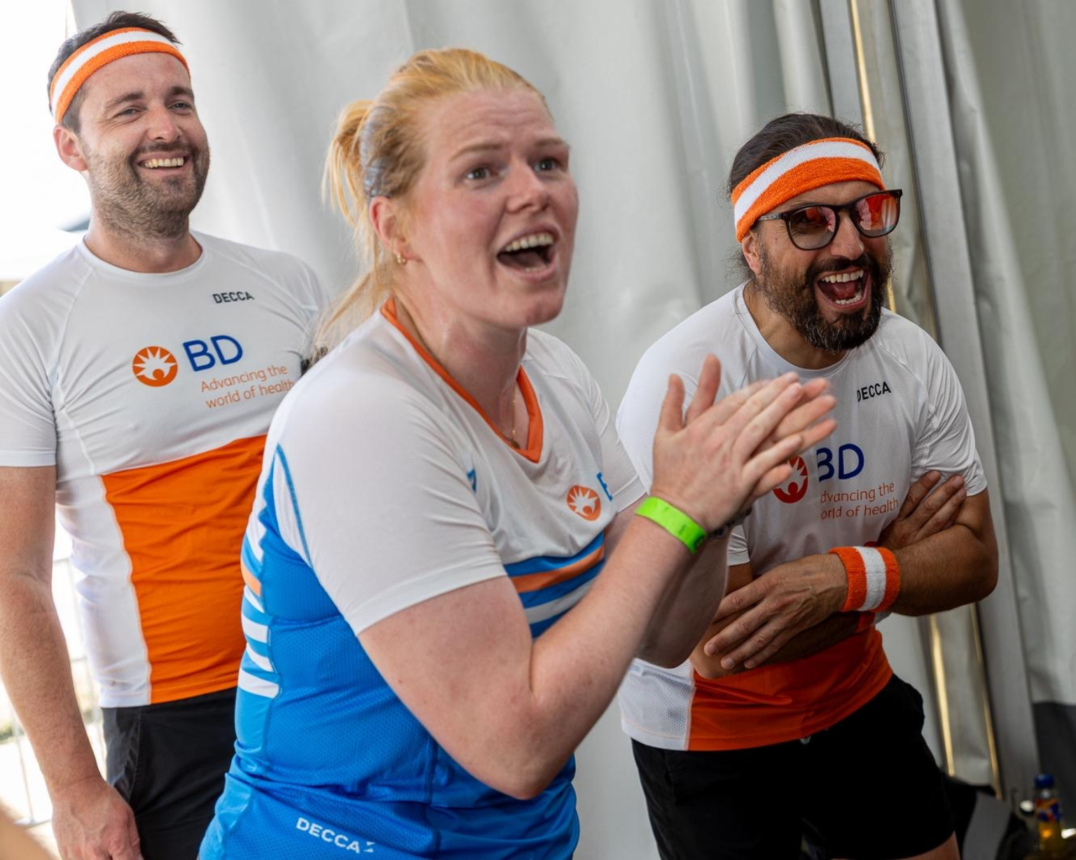 BD associates wearing BD‑branded shirts and headbands during a team activity indoors