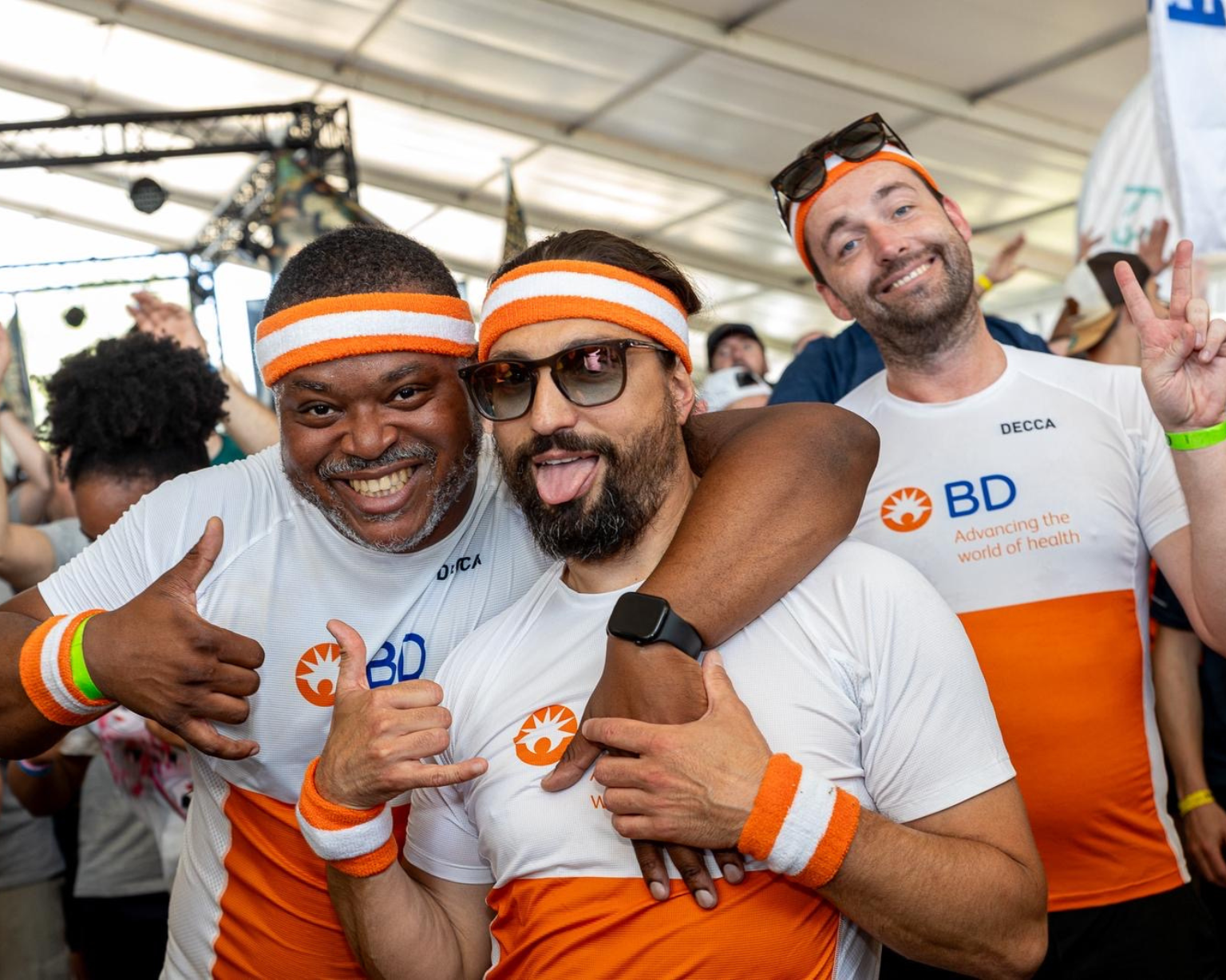 BD associates wearing BD‑branded shirts and headbands posing together at an outdoor event