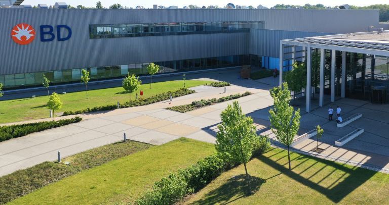 Aerial view of a BD facility with landscaped grounds and main entrance.