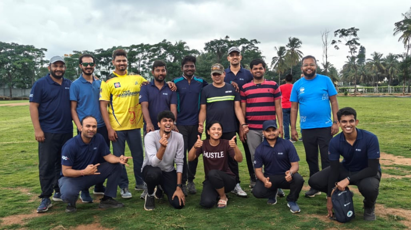BD associates posing together on a grass sports field