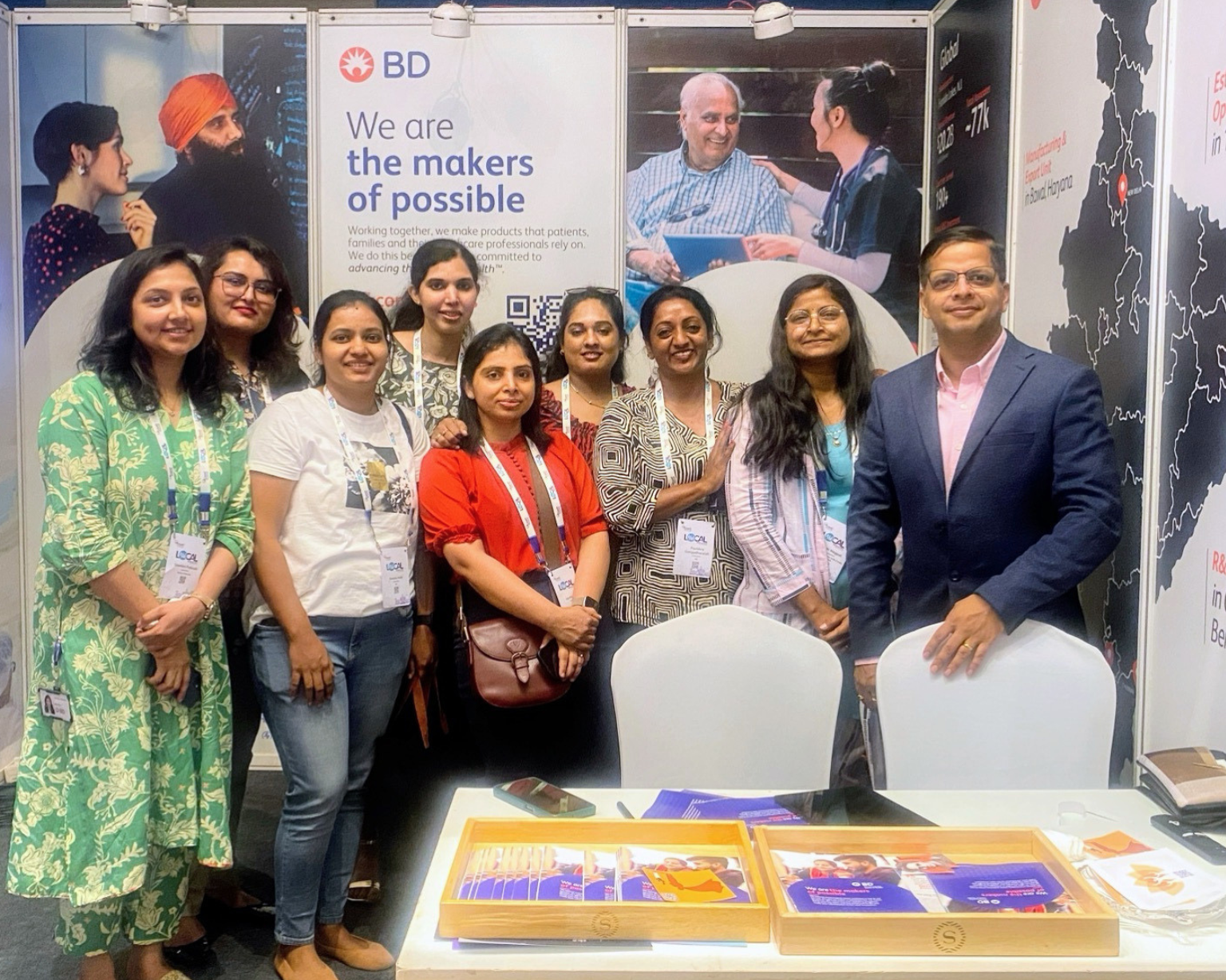 BD associates standing together at a BD branded exhibition booth.