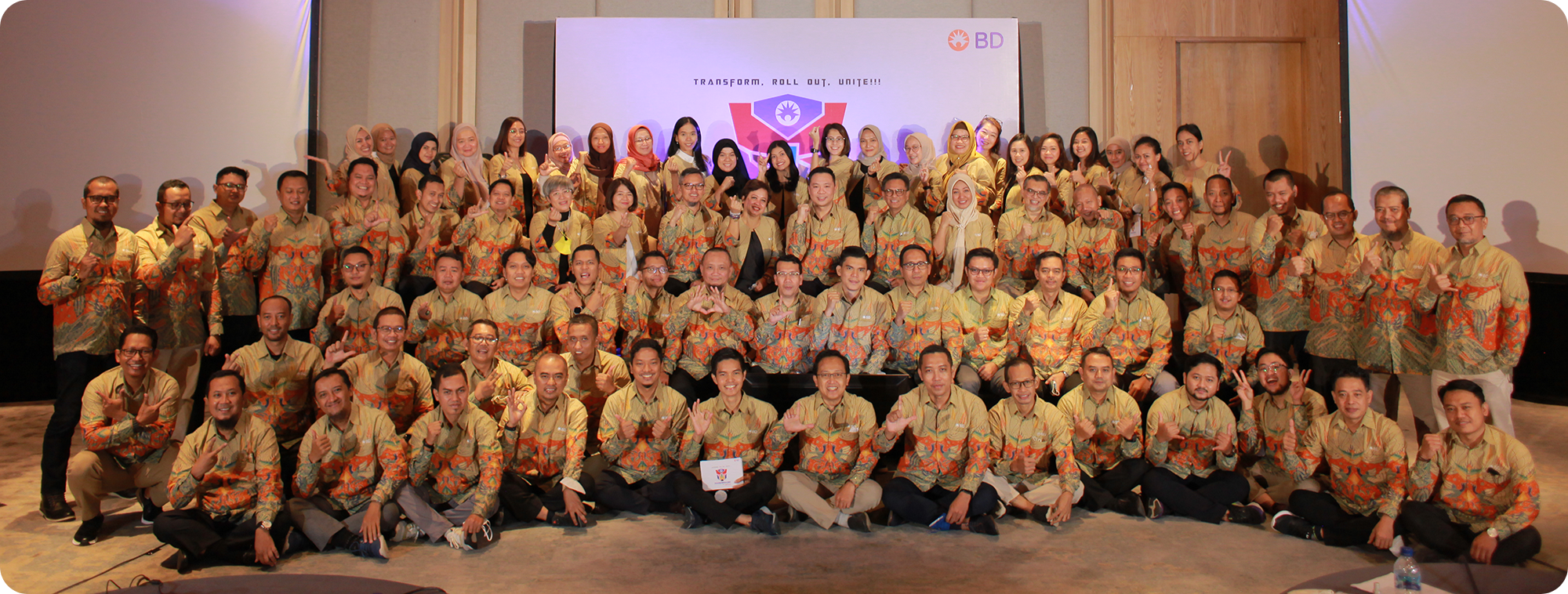 Large group of BD associates posing together at an internal event