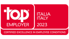 Red Top Employer certification badge displaying &ldquo;Top Employer Italia 2023&rdquo; with the tagline &ldquo;Certified Excellence in Employee Conditions&rdquo;