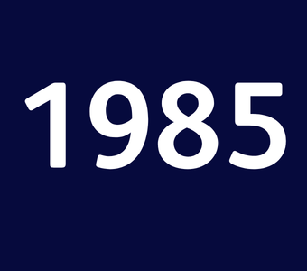 The year &ldquo;1985&rdquo; displayed in white text on a dark blue background.