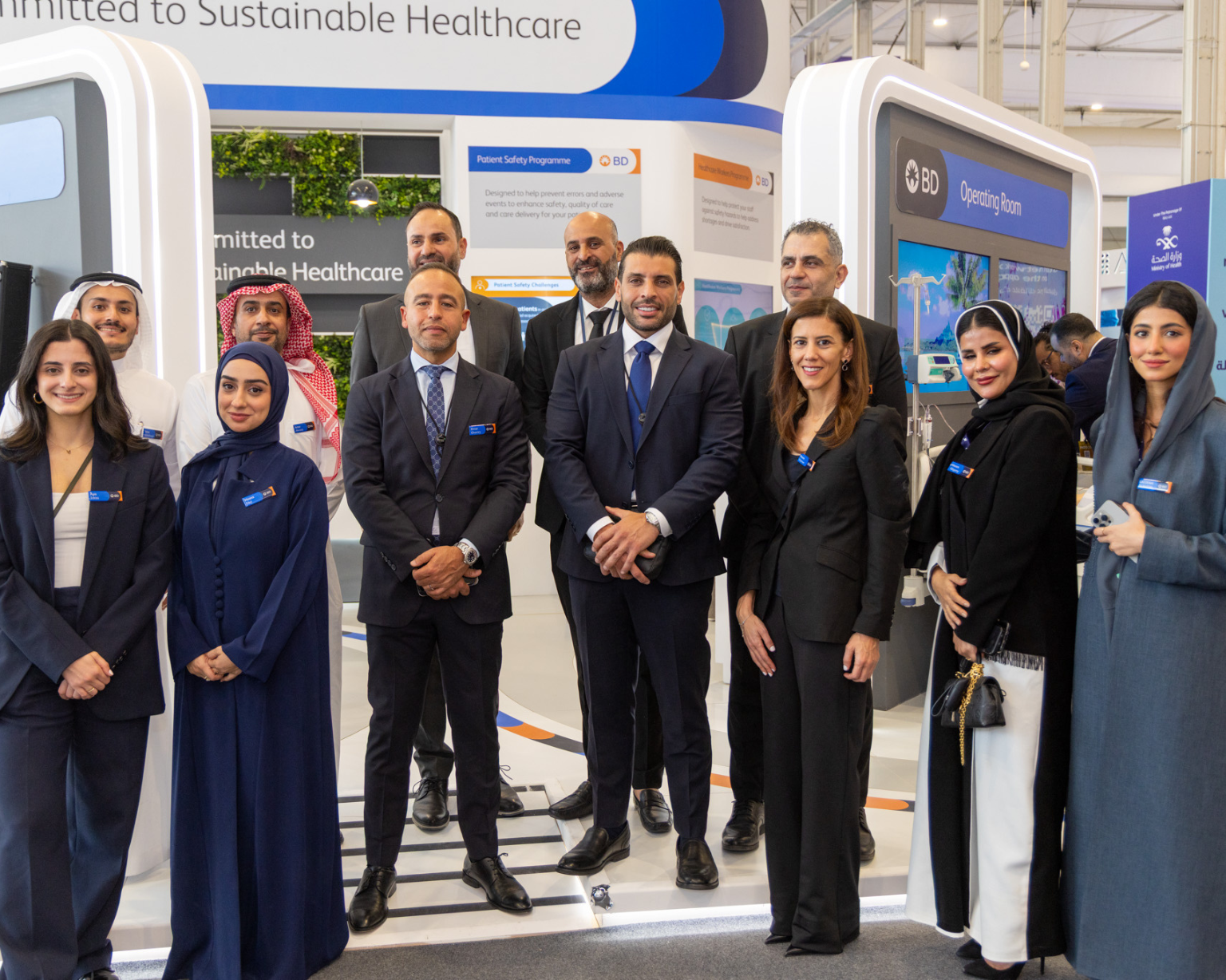 Group of BD associates standing together at a BD‑branded exhibition booth.