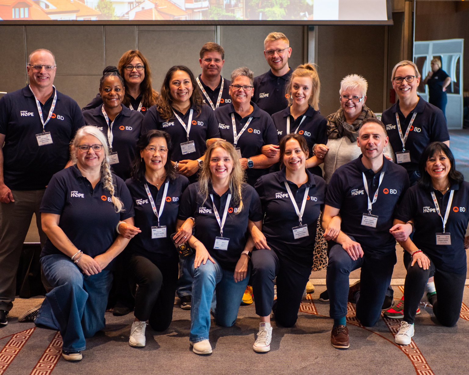Group of BD associates posing together wearing matching navy BD t-shirts