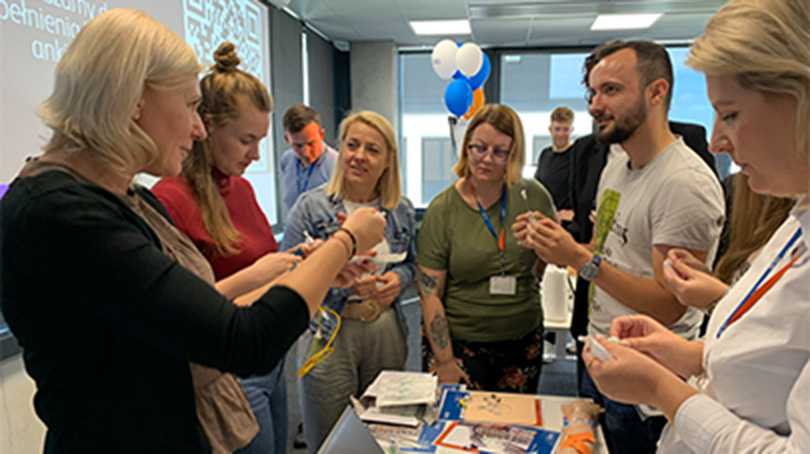 Group of BD associates gathered indoors taking part in a BD Product Showcase activity.