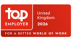 Red Top Employer certification badge displaying &ldquo;Top Employer United Kingdom 2026&rdquo; with the tagline &ldquo;For a Better World of Work.&rdquo;