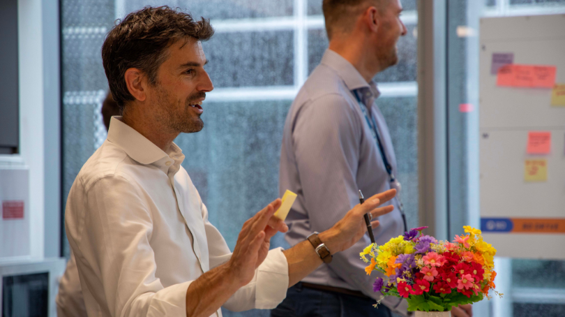 BD associates collaborating indoors during a workshop with notes and materials displayed.