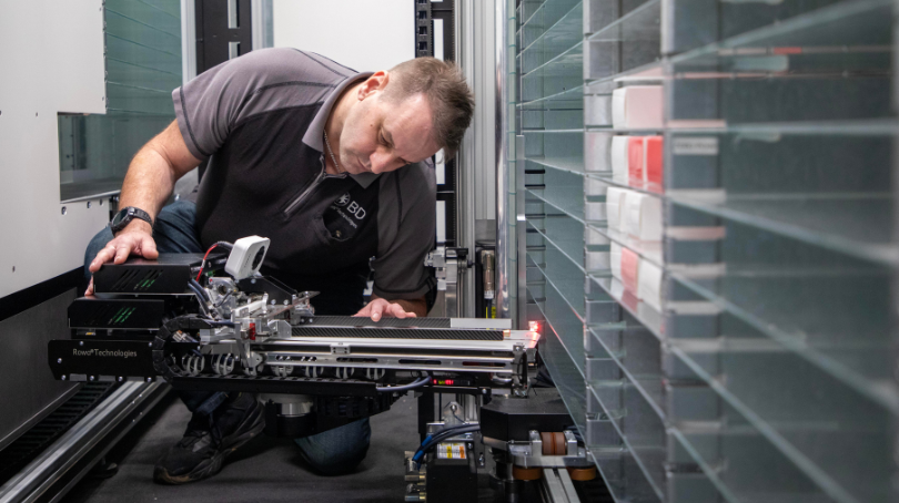 BD associate working with automated equipment inside robotic machinery.