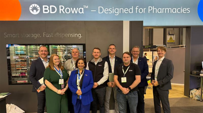 Group of BD associates standing together at a BD Rowa exhibition booth.