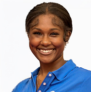 Individual wearing a blue collared shirt with a BD logo, photographed in a close-up portrait against a white background.