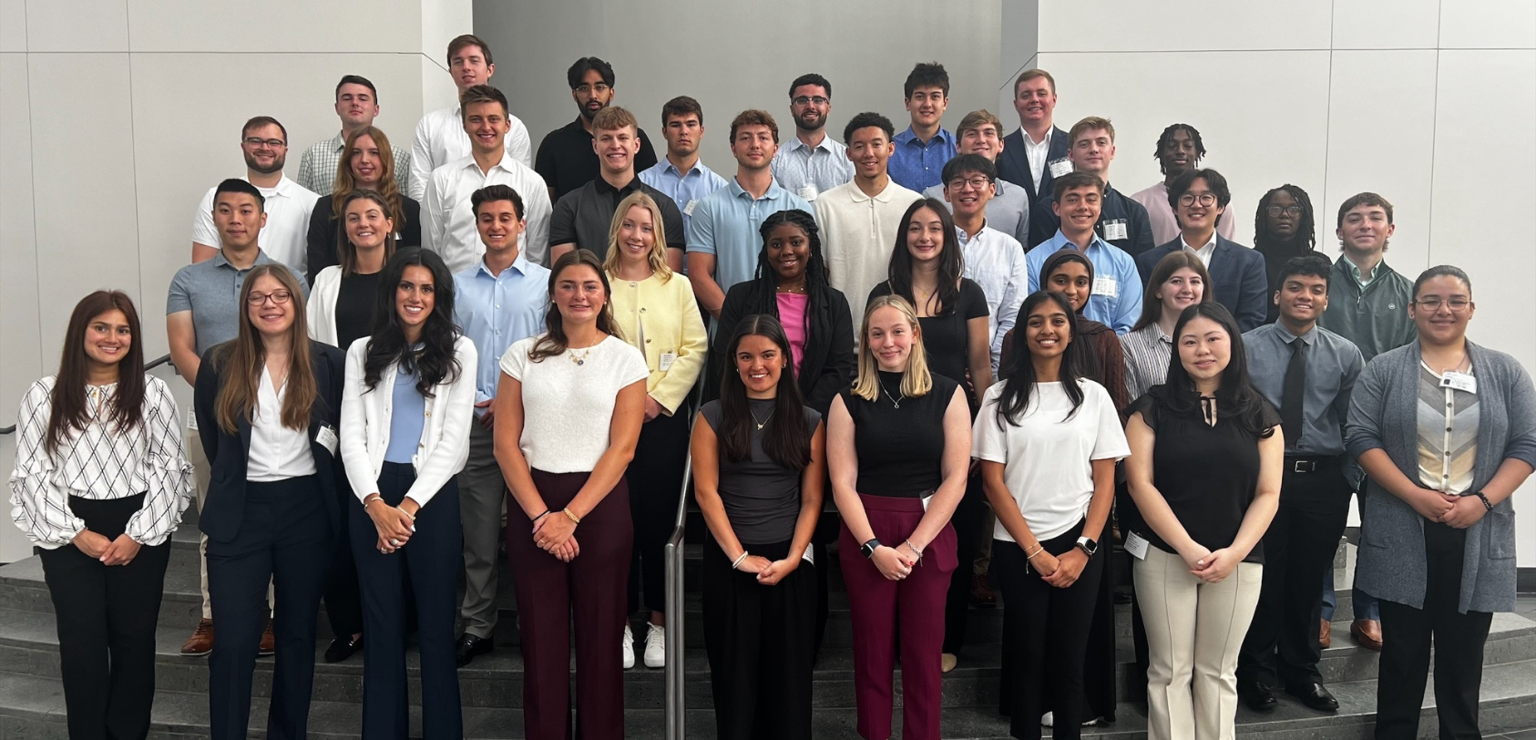 Large group of BD associates standing together indoors for a group photo.