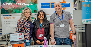 Three BD associates in a BD office smiling for a group photo