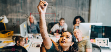 A woman writing on a whiteboard