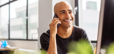 A man smiling on the phone