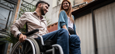 A man in a wheelchair and woman talking