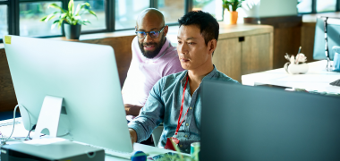 Two men looking at a computer screen