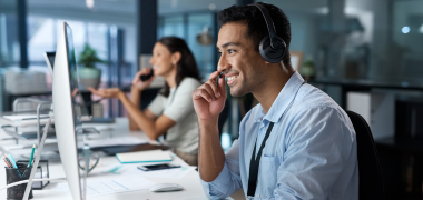 A man in an office talking through his headset