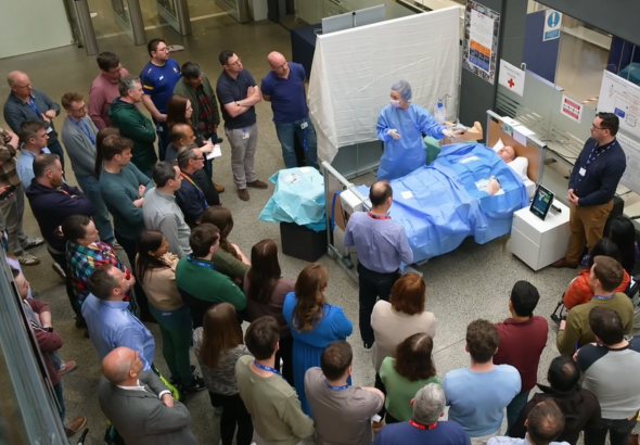 Nurse leading a demonstration to a crowd