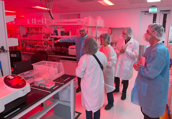 Group of people looking around laboratory