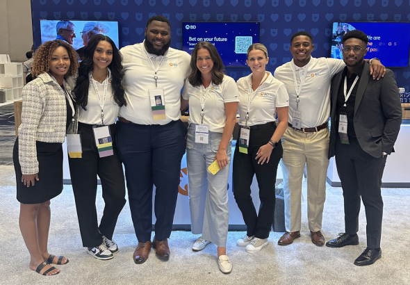 A group of BD associates at a conference