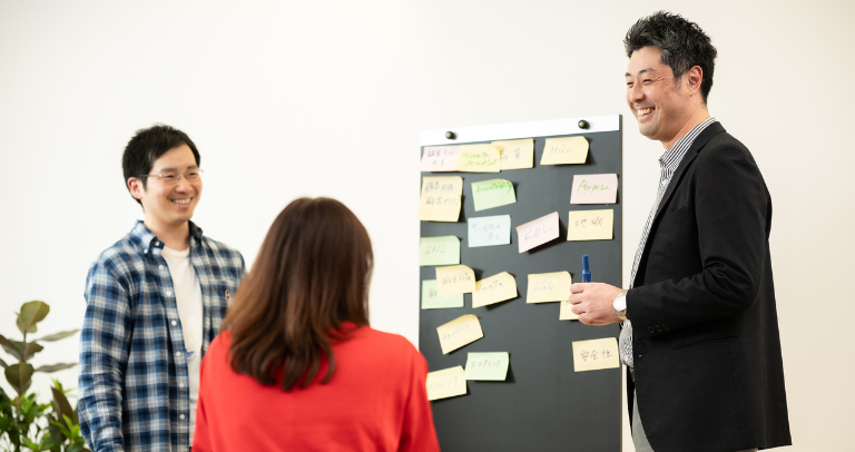 Multiple individuals at a BD exhibition booth with medical devices displayed on a central counter and branded signage about cervical cancer screening on the walls.