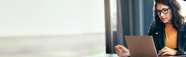 Woman sitting an working on there laptop