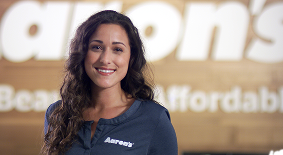 Woman smiling wearing an Aaron's blue uniform shirt