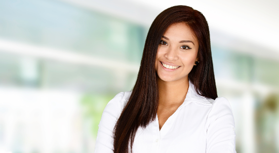 Woman with long dark hair smiling wearing white blouse