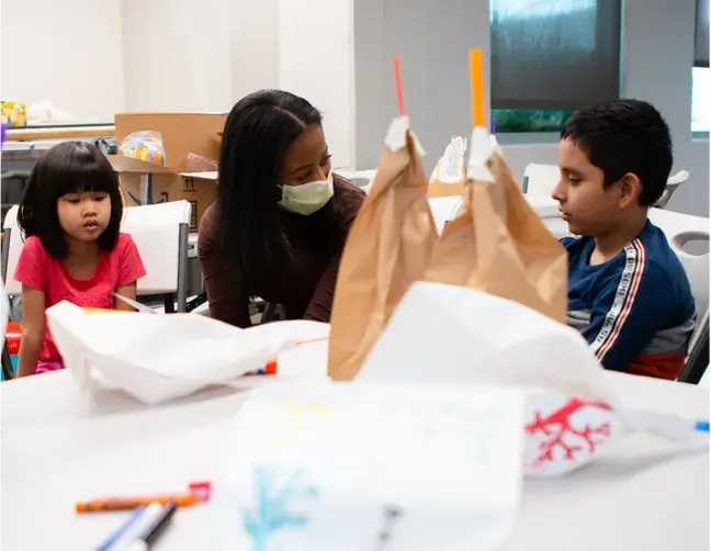 employee playing with children