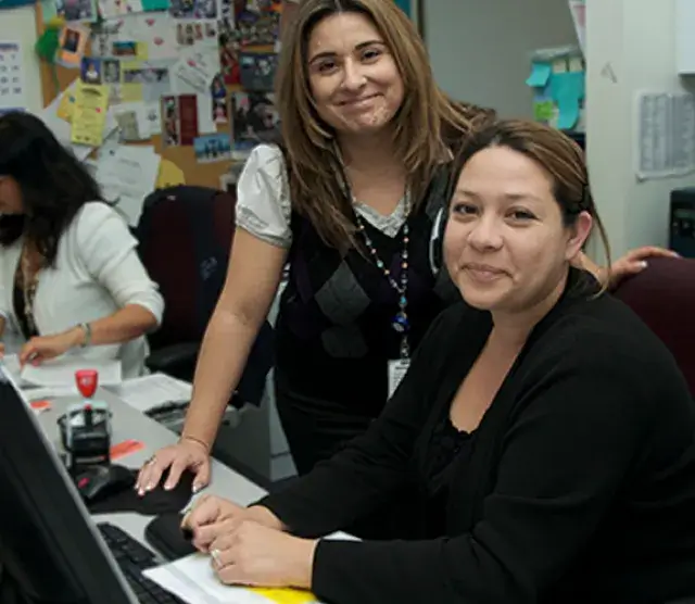 Two empoyees at a computer