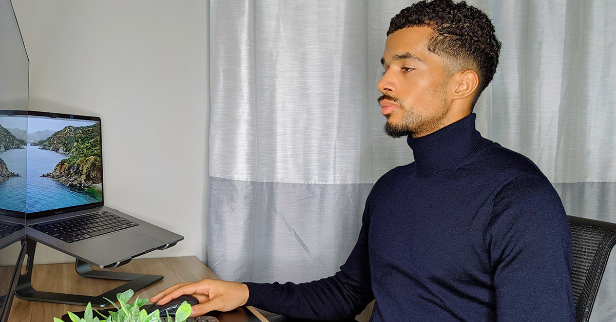 Capital One TDP associate, Carlton, works from home on his computer