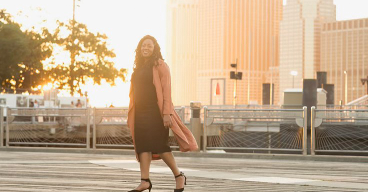 Cat Posey, a Capital One Machine Learning leader, stands at sunset and talks about women in Tech at Capital One