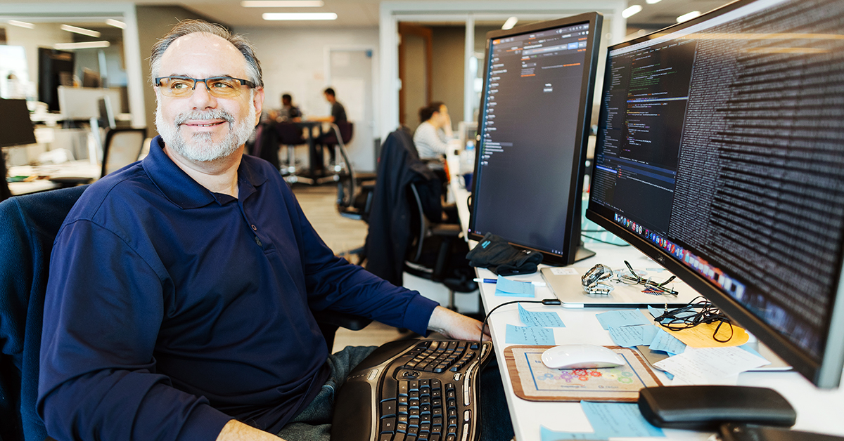 Capital One Software Engineer sits at his desk