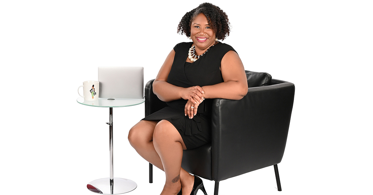 Dr. Jennifer J. Bryant, Director of Associate Experience for the Cyber Team at Capital One who won the Julie A. Elberfeld Tech Diversity, Inclusion and Belonging Awards Trailblazer Award, sits in a white room.