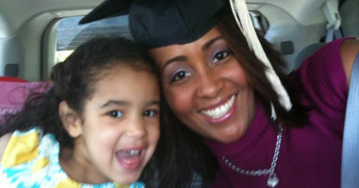 Capital One associate Judith wearing her graduation cap with her daughter