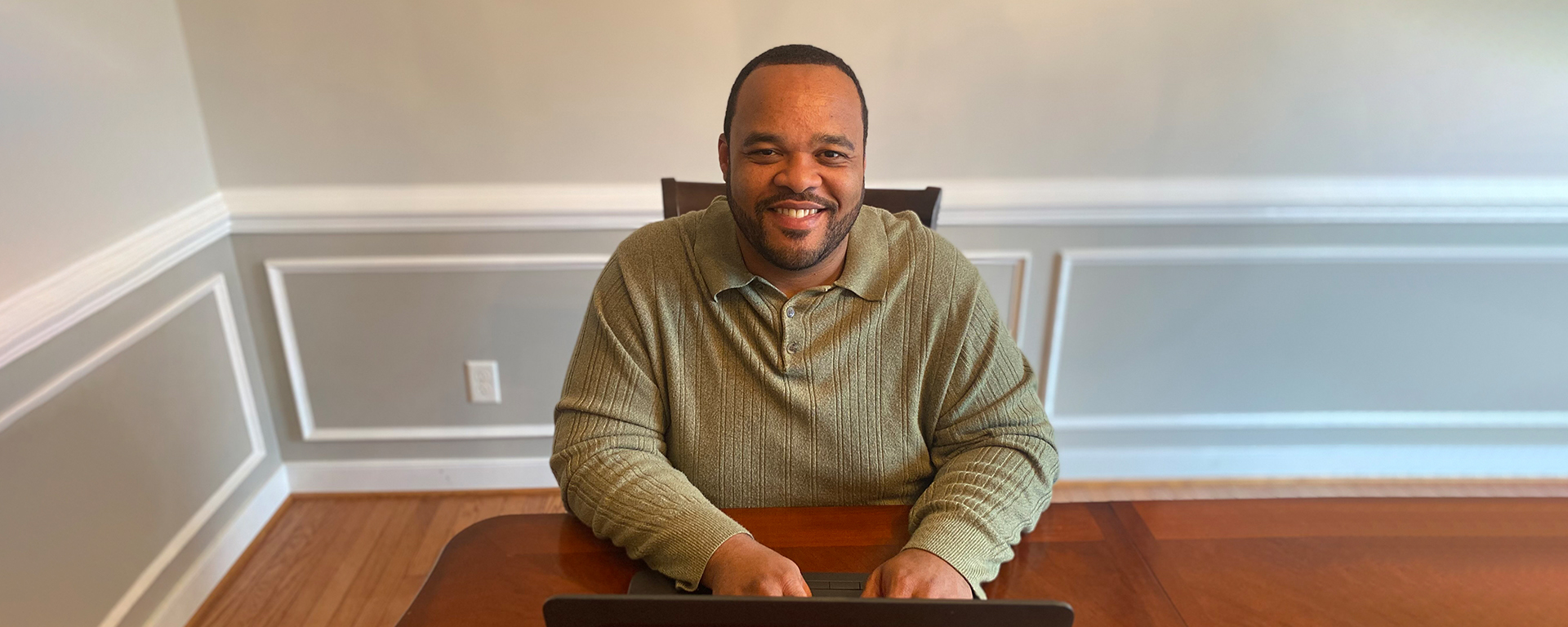 Tyrell, a Capital One associate, sits at his desk working from home and talks about Capital One having his dream job