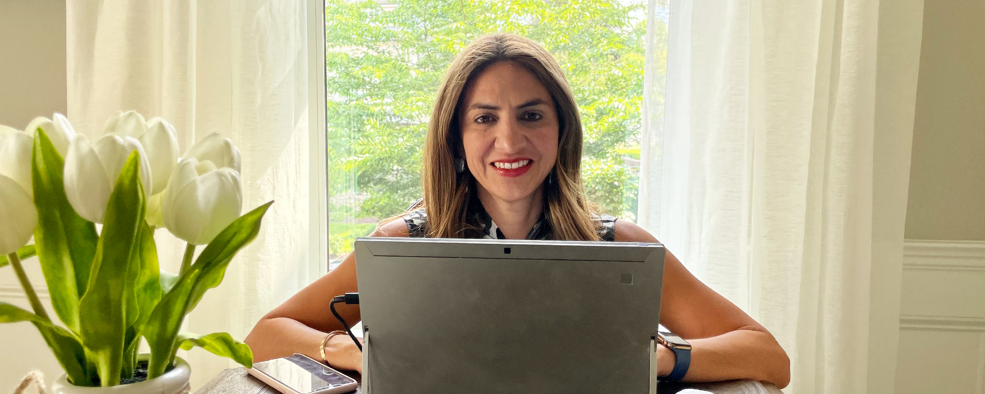 Cinthia Lopez, Capital One VP of Students and Grads Recruiting and Programs, sits at her desk behind her laptop and talks about the lessons she's learned in leadership