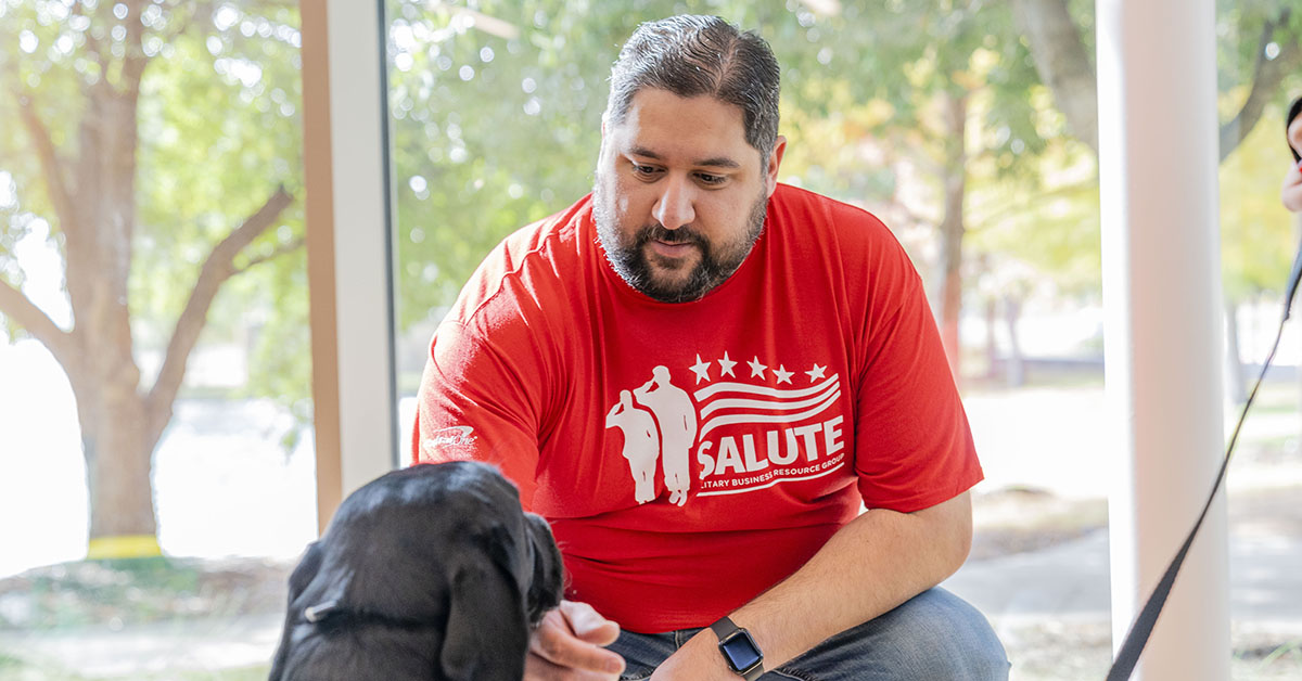 Capital One partnering with Patriot PAWS, a non-profit organization, to raise a service dog in training in the office setting