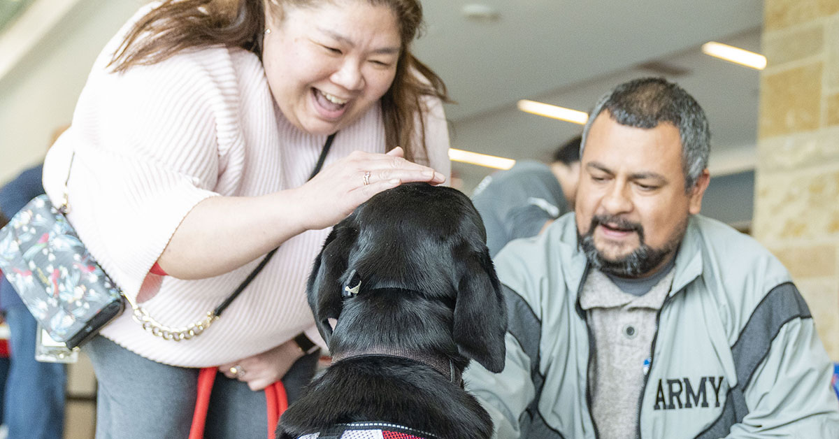 Capital One partnering with Patriot PAWS, a non-profit organization, to raise a service dog in training in an office setting at Capital One