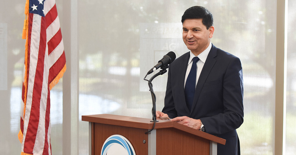Sanjib Yajnik, president of Capital One's Financial Services, stands at a podium and gives a speech about the lessons he's learned in leadership