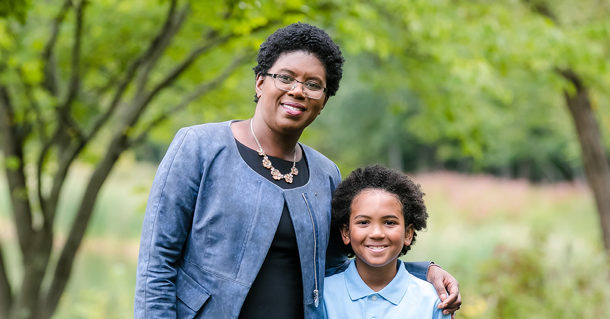 Capital One HR Tech leader Maureen Jules-Perez stands outside with her son and shares her thoughts on Diversity