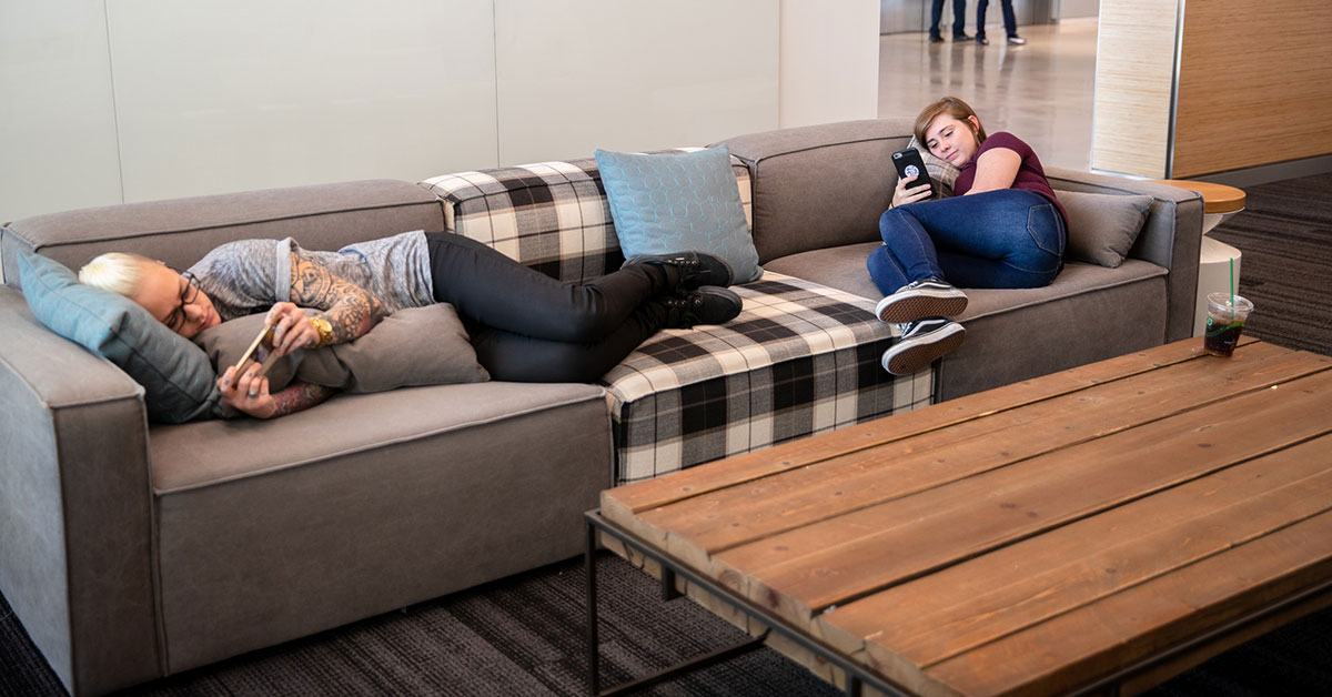 women relaxing on a couch at work