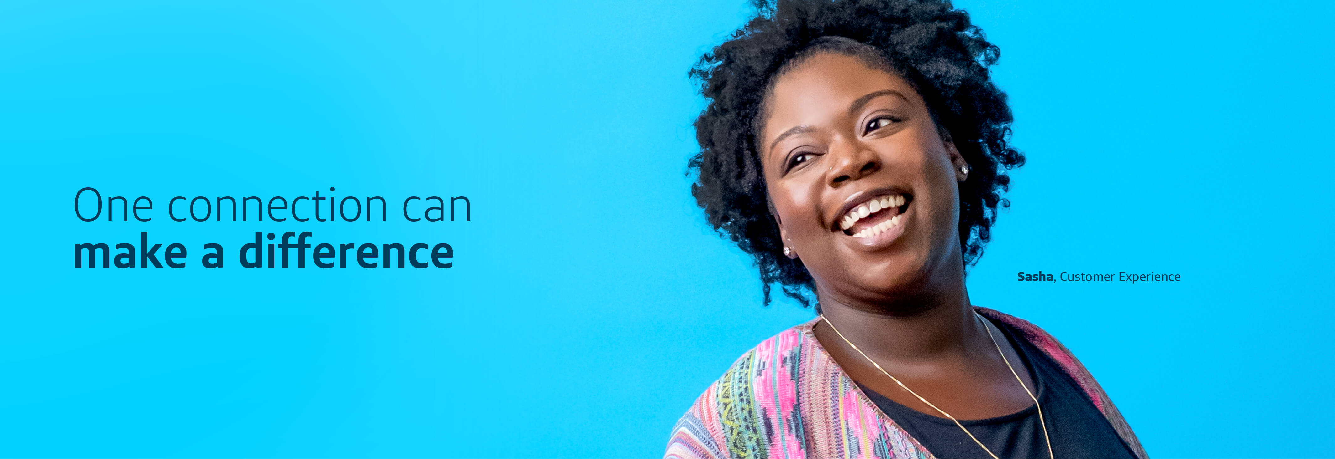Sasha, a Capital One Customer Experience associate, stands in front of a blue background smiling next to a quote that says, "One connection can make a difference"