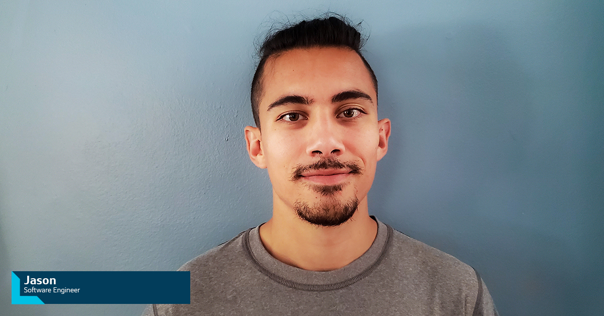 Jason, Capital One Software Engineer, stands in front of a soft blue wall