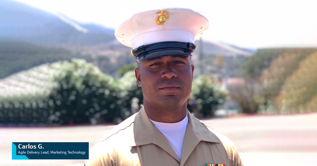 Capital One Military Veteran associate Carlos G., Agile Delivery Lead, Marketing Technology, stands outside in his military uniform